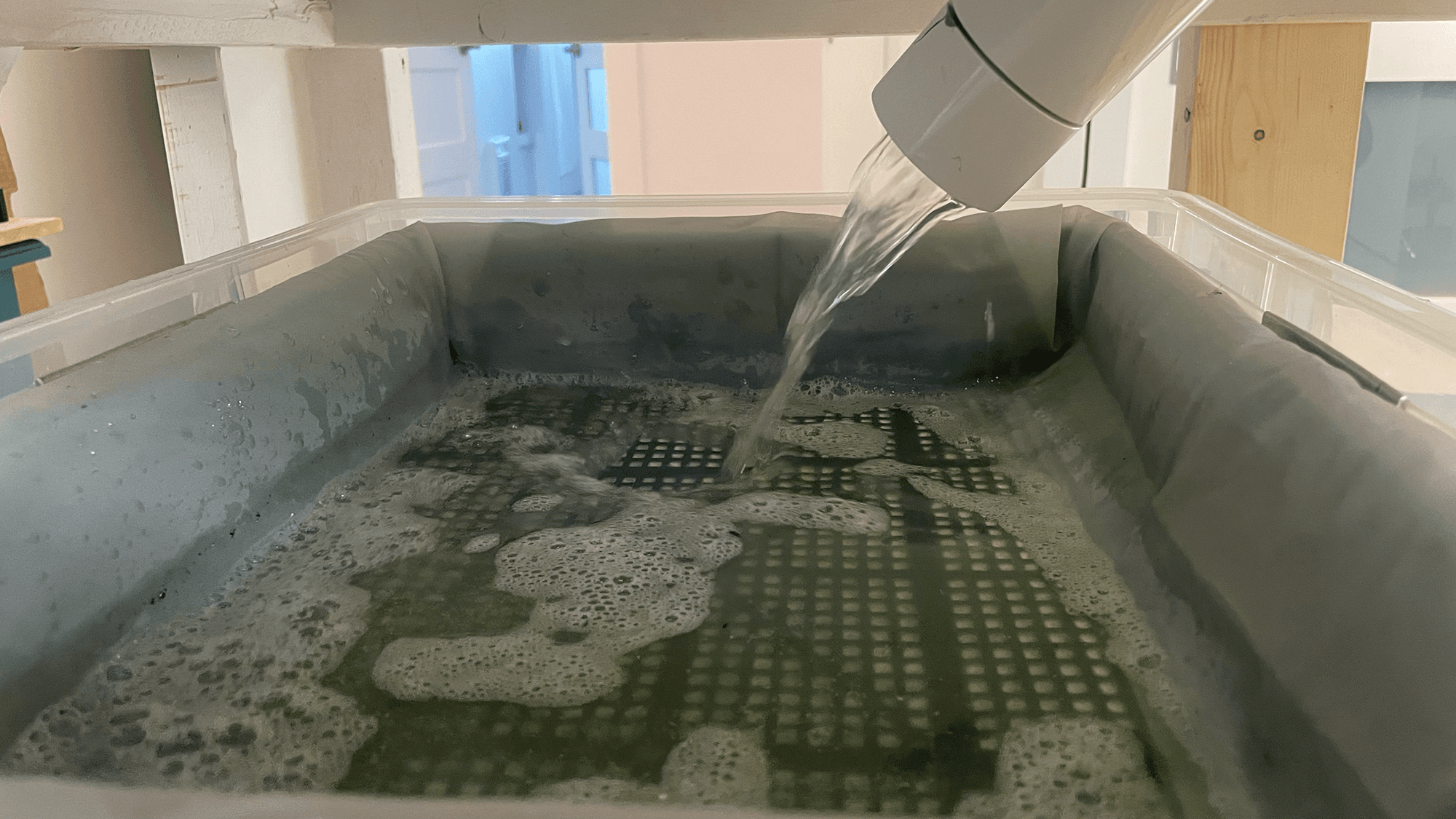 Old mesh clogged and pooling coolant in the chip basket