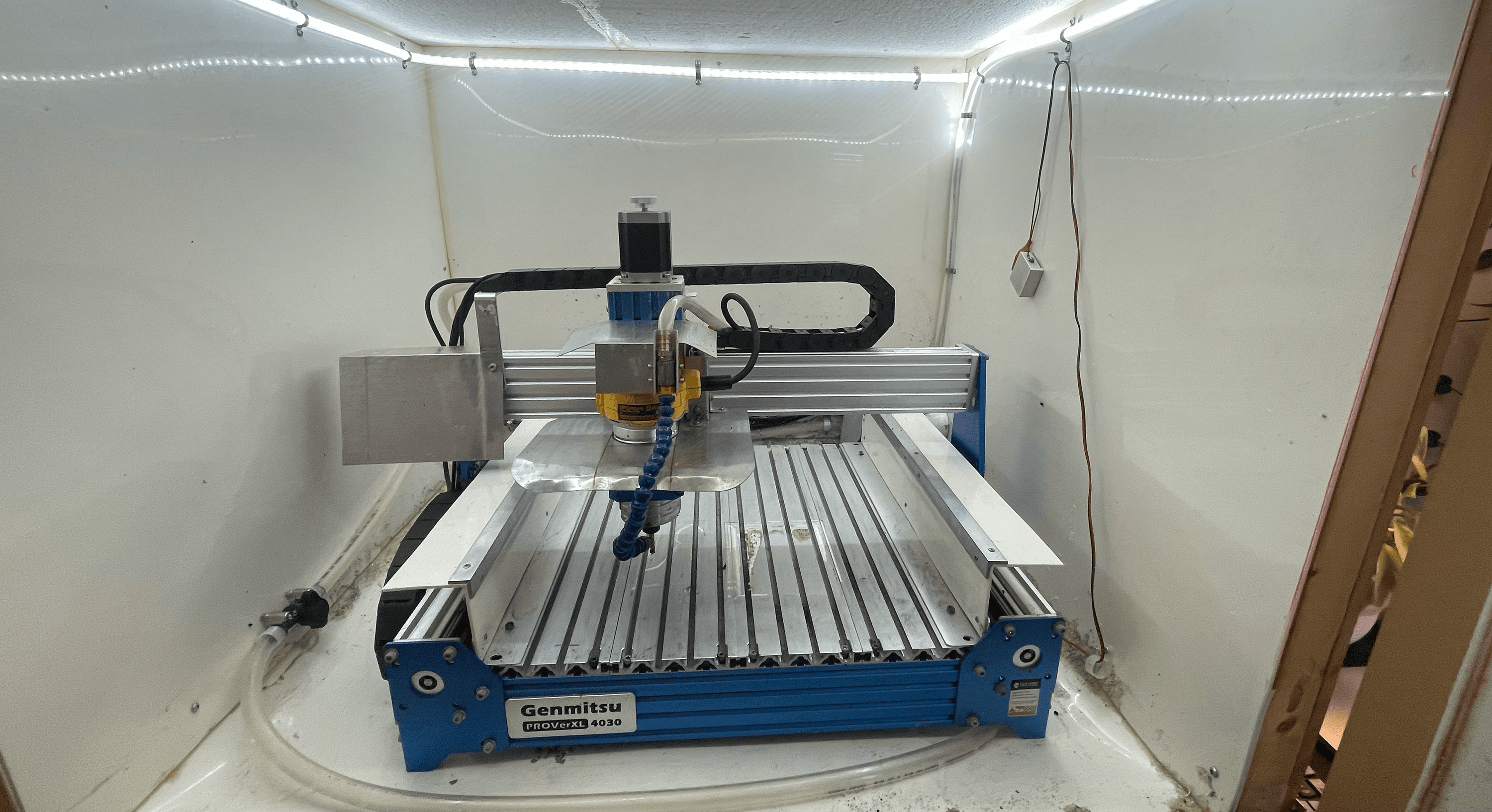CNC machine inside plastic lined enclosure
